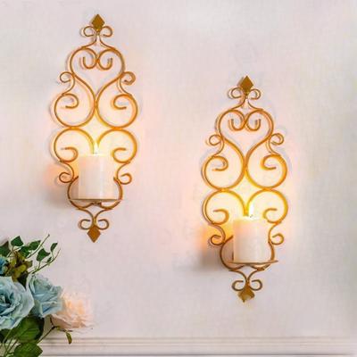 Wall-mounted candle holders with scrollwork design, golden metal, for weddings and parties
